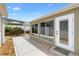 Backyard featuring a patio, landscaped area, and a walk-out door to the home's interior at 2465 Violet Ct, The Villages, FL 32162