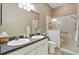 Spacious main bathroom with double vanity, walk-in shower, and modern fixtures for comfortable living at 2465 Violet Ct, The Villages, FL 32162