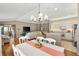 Open layout of dining area, living room and kitchen, hardwood floors, large windows at 2465 Violet Ct, The Villages, FL 32162