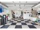 Spacious garage with checkerboard flooring, ample storage, and utility connections at 2465 Violet Ct, The Villages, FL 32162