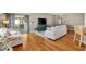 Open-concept living area with sliding glass doors, hardwood floors, and stylish furnishings at 2465 Violet Ct, The Villages, FL 32162