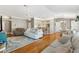 Bright and airy living room with hardwood floors flowing into kitchen and dining areas at 2465 Violet Ct, The Villages, FL 32162