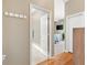 Bright main bedroom entrance featuring hardwood floors, hallway closet, and ensuite bathroom at 2465 Violet Ct, The Villages, FL 32162