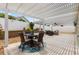 Inviting outdoor patio featuring a pergola, landscaping, and comfortable seating for entertaining at 2465 Violet Ct, The Villages, FL 32162