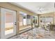 Bright sunroom with comfortable wicker furniture and large windows offering ample natural light at 2465 Violet Ct, The Villages, FL 32162
