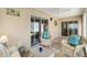 Relaxing sunroom with wicker seating, a ceiling fan, and sliding glass doors for indoor-outdoor living at 2465 Violet Ct, The Villages, FL 32162