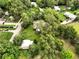 Scenic aerial view showcasing a charming home surrounded by lush greenery and mature trees at 25888 Se 157Th Ln, Umatilla, FL 32784