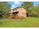 Exterior view of a charming barn with two stories and a rustic design surrounded by lush greenery at 25888 Se 157Th Ln, Umatilla, FL 32784