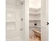 Bathroom featuring a shower, shelves, and a louvered door to the outside at 25888 Se 157Th Ln, Umatilla, FL 32784