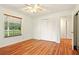 Cozy bedroom featuring wood-look floors, a window with blinds, and a spacious closet at 25888 Se 157Th Ln, Umatilla, FL 32784