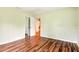 Bedroom featuring hardwood flooring and a closet with mirrored doors at 25888 Se 157Th Ln, Umatilla, FL 32784