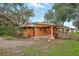 Charming single-story home featuring an inviting porch, attached covered parking, and spacious outdoor area at 25888 Se 157Th Ln, Umatilla, FL 32784
