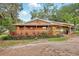Charming single-story home featuring a cozy porch and well-maintained landscaping and attached covered parking at 25888 Se 157Th Ln, Umatilla, FL 32784