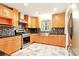 Modern kitchen featuring stainless steel appliances, stylish backsplash, and custom cabinets at 25888 Se 157Th Ln, Umatilla, FL 32784