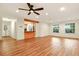 Bright living room featuring recessed lighting, wood-look floors, and a view into the kitchen at 25888 Se 157Th Ln, Umatilla, FL 32784
