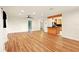 Spacious living room featuring wood-look flooring, a ceiling fan, and an open view to the kitchen at 25888 Se 157Th Ln, Umatilla, FL 32784