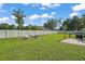 Expansive backyard with white fencing, a fire pit, and outdoor seating area at 314 Stone Castle Loop, Lady Lake, FL 32159