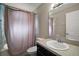 Bathroom featuring a single sink vanity with a shower and tub combination with a shower curtain at 314 Stone Castle Loop, Lady Lake, FL 32159