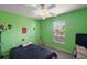 Bright bedroom with a ceiling fan, large window, and playful decor at 314 Stone Castle Loop, Lady Lake, FL 32159