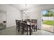 Bright dining room with a modern chandelier, natural light, and space for entertaining at 314 Stone Castle Loop, Lady Lake, FL 32159