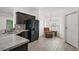 Bright kitchen with wood-look tile flooring, stainless steel appliances, and a charming breakfast nook at 314 Stone Castle Loop, Lady Lake, FL 32159