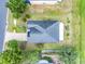 Birds eye view of the house from above, showing roof line, large yard and neighborhood streets at 3213 White Blossom Ln, Clermont, FL 34711