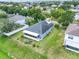 Aerial view of the property showing a large lot with mature landscaping and a screened-in lanai at 3213 White Blossom Ln, Clermont, FL 34711