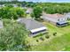 Aerial view of home showing large yard, mature trees, screened in patio, and neighborhood at 3213 White Blossom Ln, Clermont, FL 34711
