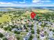 Aerial view of neighborhood showing location surrounded by green fields and blue sky at 3213 White Blossom Ln, Clermont, FL 34711