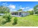 A house with a screened lanai and backyard in view at 3213 White Blossom Ln, Clermont, FL 34711