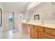 Bright bathroom with a makeup vanity and a door to the outside at 3213 White Blossom Ln, Clermont, FL 34711