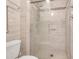 Modern bathroom featuring an enclosed glass shower with gray stone-look tile and contemporary fixtures at 3213 White Blossom Ln, Clermont, FL 34711