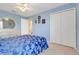 Bedroom featuring a bed, dresser with a round mirror, and closet with bi-fold doors at 3213 White Blossom Ln, Clermont, FL 34711