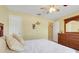 Bedroom featuring a bed, dresser and an ensuite bathroom through an open door at 3213 White Blossom Ln, Clermont, FL 34711