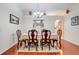 Elegant dining room with hardwood floors, a chandelier, and a table set for six at 3213 White Blossom Ln, Clermont, FL 34711