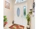 Elegant front door with decorative glass insert, sidelight, and attractive entryway decor at 3213 White Blossom Ln, Clermont, FL 34711