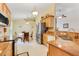 Bright kitchen with light wood cabinets, granite countertops, stainless steel appliances, and a breakfast nook at 3213 White Blossom Ln, Clermont, FL 34711