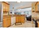Spacious kitchen featuring granite countertops, stainless steel appliances, and open layout to the living area at 3213 White Blossom Ln, Clermont, FL 34711