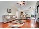 Spacious living room featuring hardwood floors and comfortable leather couches at 3213 White Blossom Ln, Clermont, FL 34711