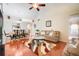 Inviting living room and dining area with warm wood floors and a cozy seating arrangement at 3213 White Blossom Ln, Clermont, FL 34711