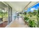 Screened-in lanai with tile flooring, table, and views of the backyard landscape at 3213 White Blossom Ln, Clermont, FL 34711