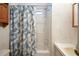 Bathroom features a shower and tub combination with a floral shower curtain at 32339 Oak Park Dr, Leesburg, FL 34748