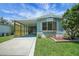 Lovely blue home with a spacious carport and manicured front yard at 32339 Oak Park Dr, Leesburg, FL 34748
