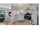 Bright kitchen with stainless steel range and an open view to the living room at 32339 Oak Park Dr, Leesburg, FL 34748