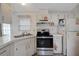 Galley kitchen featuring updated stainless steel appliances at 32339 Oak Park Dr, Leesburg, FL 34748