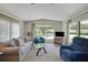 Comfortable living room showcasing a sofa, armchair, and large bay window at 32339 Oak Park Dr, Leesburg, FL 34748