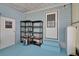 Storage area with blue flooring and shelving unit for added convenience at 32339 Oak Park Dr, Leesburg, FL 34748