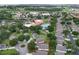 Aerial view highlights property lines and showcases proximity to community amenities including pool and nearby shopping at 3605 Kingswood Ct, Clermont, FL 34711