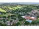 An aerial view highlighting the property's proximity to the community pool, golf course, and nearby shopping at 3605 Kingswood Ct, Clermont, FL 34711