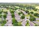 Sprawling aerial view of a residential community nestled among lush green trees and a golf course at 3605 Kingswood Ct, Clermont, FL 34711